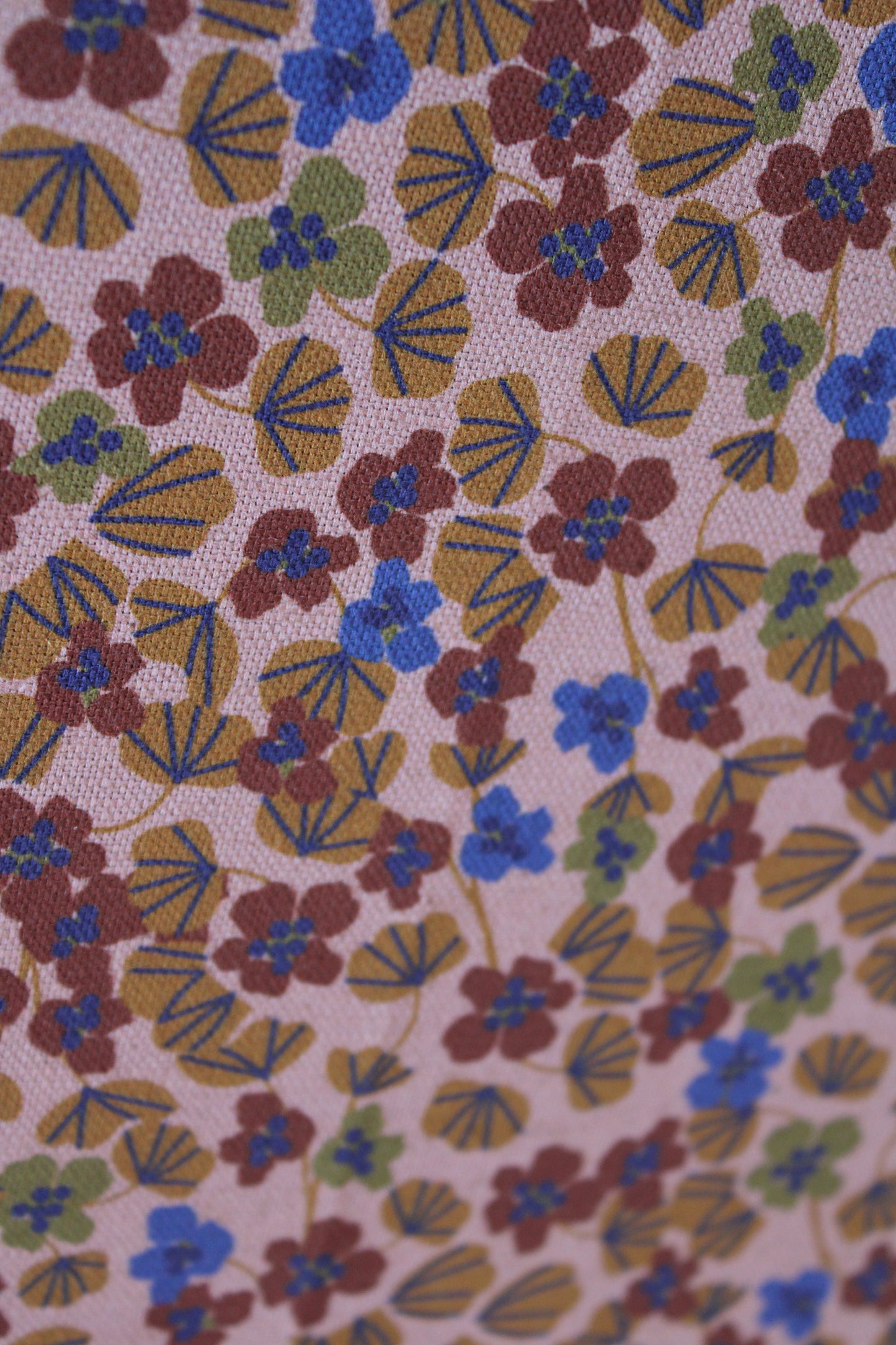 Floral pattern with brown, blue, and green flowers on a beige background