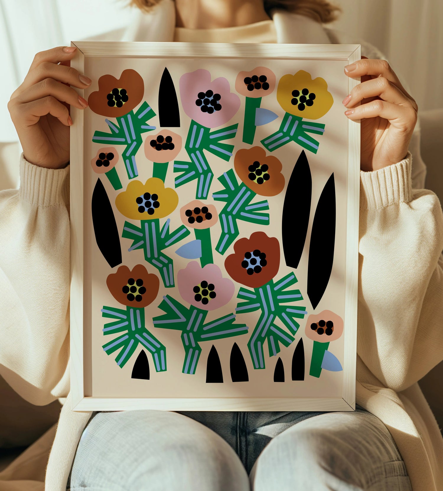 woman holding framed print with large folk art modern floral