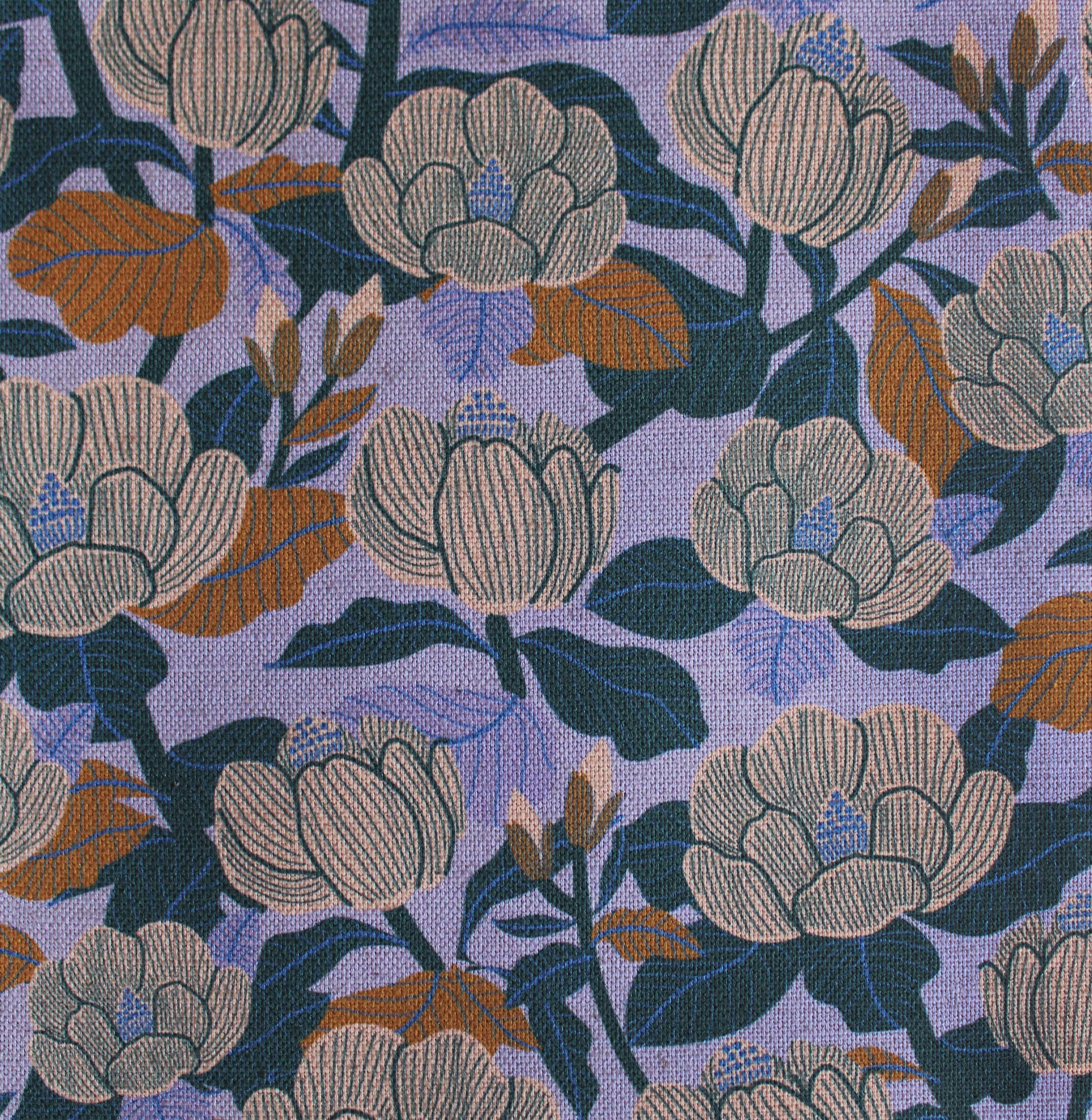Floral patterned fabric with large flowers on a purple background