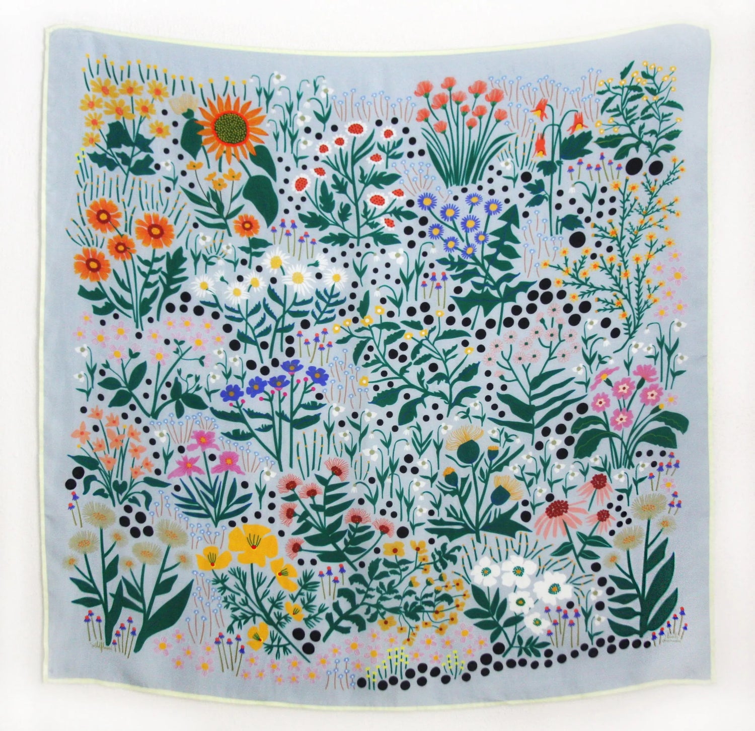 Square silk scarf with colorful wildflower and garden-inspired design by Leah Duncan on light background