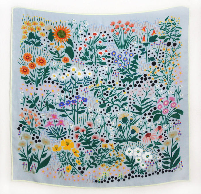 Square silk scarf with colorful wildflower and garden-inspired design by Leah Duncan on light background