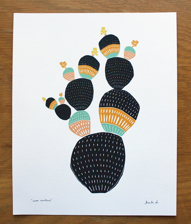 Archival print of a modern Wee Cactus drawing in indigo, orange, teal, and yellow on white artisan paper.